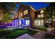Beautiful backyard featuring a covered patio, manicured lawn, and second story balcony at 9704 Royal Lamb Dr, Las Vegas, NV 89145