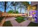 Picturesque backyard showcasing a patio area, lush lawn, and mature trees, perfect for outdoor enjoyment at 9704 Royal Lamb Dr, Las Vegas, NV 89145