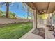 Relax in the backyard with its covered patio, lush lawn, privacy landscaping, and built-in grill area at 9704 Royal Lamb Dr, Las Vegas, NV 89145