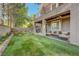Enjoy the spacious backyard with a covered patio, lush lawn, balcony, and beautiful landscaping at 9704 Royal Lamb Dr, Las Vegas, NV 89145