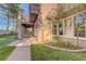 Landscaped backyard with covered patio, built-in grill, stone walkway, lawn and flourishing foliage at 9704 Royal Lamb Dr, Las Vegas, NV 89145