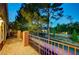 Upper level balcony with views of mature trees and neighboring rooftops, offering a serene outdoor space at 9704 Royal Lamb Dr, Las Vegas, NV 89145