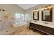 Bathroom with a large bathtub, walk-in shower, and double sink vanity at 9704 Royal Lamb Dr, Las Vegas, NV 89145