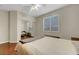A bedroom with wood floors, a queen bed, and sliding closet doors with a ceiling fan at 9704 Royal Lamb Dr, Las Vegas, NV 89145
