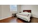 A cozy bedroom featuring wood floors, a queen bed, and a bedside table at 9704 Royal Lamb Dr, Las Vegas, NV 89145