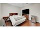 A bedroom with wood floors, a queen bed, and a tv with stand at 9704 Royal Lamb Dr, Las Vegas, NV 89145