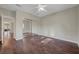 A spacious bedroom with dark hardwood floors and closet with mirrored doors at 9704 Royal Lamb Dr, Las Vegas, NV 89145