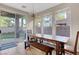 Bright dining area with a long wooden table and access to the patio at 9704 Royal Lamb Dr, Las Vegas, NV 89145