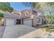 Charming two-story home featuring a three-car garage and a well-manicured lawn with mature trees at 9704 Royal Lamb Dr, Las Vegas, NV 89145