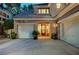 Front exterior shot of home featuring a three car garage and covered entry at 9704 Royal Lamb Dr, Las Vegas, NV 89145