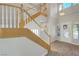 Spacious foyer featuring wood and white staircase with wood-look floors and an ornate glass front door at 9704 Royal Lamb Dr, Las Vegas, NV 89145