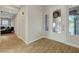 Inviting foyer featuring wood-look tile flooring and a decorative glass front door, with natural light at 9704 Royal Lamb Dr, Las Vegas, NV 89145