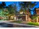 A charming two-story home with a well-manicured lawn and mature trees at 9704 Royal Lamb Dr, Las Vegas, NV 89145