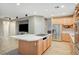 Spacious kitchen with island cooktop, stainless refrigerator and wood cabinets at 9704 Royal Lamb Dr, Las Vegas, NV 89145