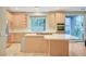 Bright kitchen features an island cooktop, stainless refrigerator, and a sliding door to the patio at 9704 Royal Lamb Dr, Las Vegas, NV 89145