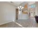 Open-concept living space boasting wood-look flooring, a statement chandelier, and an elegant staircase at 9704 Royal Lamb Dr, Las Vegas, NV 89145