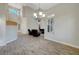 Spacious living area featuring an elegant chandelier, wood-look flooring, and an open layout at 9704 Royal Lamb Dr, Las Vegas, NV 89145