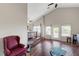 Spacious living room featuring high vaulted ceilings, ceiling fan, hardwood floors, and backyard views at 9704 Royal Lamb Dr, Las Vegas, NV 89145