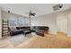 A spacious living room with dark brown leather couches and wood floors at 9704 Royal Lamb Dr, Las Vegas, NV 89145