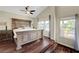 Spacious main bedroom with raised platform, hardwood floors, and natural light at 9704 Royal Lamb Dr, Las Vegas, NV 89145