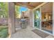 Covered patio features a built-in grill, concrete pavers, and seamless transition into the bright interior at 9704 Royal Lamb Dr, Las Vegas, NV 89145