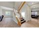 Elegant staircase with wood treads and white risers, complemented by wood-look tile flooring at 9704 Royal Lamb Dr, Las Vegas, NV 89145