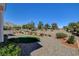 Backyard with desert landscaping, mature trees, and gravel providing serene views of the surrounding landscape at 10100 Folsom Dr, Las Vegas, NV 89134