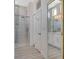 Bathroom featuring a glass-enclosed shower, double vanity, and light gray tile at 10100 Folsom Dr, Las Vegas, NV 89134