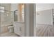 Bright bathroom with modern vanity, glass shower doors, and access to the spacious living area at 10100 Folsom Dr, Las Vegas, NV 89134