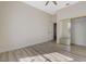 Neutral bedroom featuring light wood floors, a ceiling fan, and a mirrored closet at 10100 Folsom Dr, Las Vegas, NV 89134