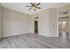 Spacious bedroom with ceiling fan and entrances to the bathroom and closet at 10100 Folsom Dr, Las Vegas, NV 89134