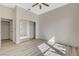 Spacious bedroom featuring light wood floors, a ceiling fan, and a mirrored closet at 10100 Folsom Dr, Las Vegas, NV 89134