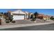 Charming single-story home showcasing a manicured front yard, red tile roof, and a spacious two-car garage at 10100 Folsom Dr, Las Vegas, NV 89134