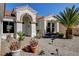 Beautiful home featuring a welcoming entrance, complemented by lush landscaping and a serene bench at 10100 Folsom Dr, Las Vegas, NV 89134