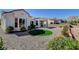Well-maintained front yard with desert landscaping, gravel, and a touch of green with an elevated lawn at 10100 Folsom Dr, Las Vegas, NV 89134