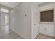 Hallway with light-colored walls, flooring, and a stylish built-in counter at 10100 Folsom Dr, Las Vegas, NV 89134