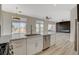 Stylish kitchen with a marble island, stainless steel appliances, and views into an adjacent living area with modern fireplace at 10100 Folsom Dr, Las Vegas, NV 89134