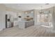 Modern kitchen boasting an island with marble countertop, stainless steel appliances, and a sunlit breakfast nook at 10100 Folsom Dr, Las Vegas, NV 89134