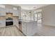 Contemporary kitchen featuring a marble-topped island, stainless steel appliances, and sliding glass doors to an outdoor space at 10100 Folsom Dr, Las Vegas, NV 89134