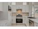 Bright modern kitchen with stainless steel appliances, marble countertops and backsplash, and ample counter space at 10100 Folsom Dr, Las Vegas, NV 89134