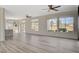 The living room has large windows for light, and luxury vinyl plank flooring at 10100 Folsom Dr, Las Vegas, NV 89134