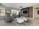 This is a staged living room with a modern fireplace, TV, and neutral furnishings at 10100 Folsom Dr, Las Vegas, NV 89134