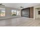 Living room with luxury vinyl plank flooring, a fireplace, and ample natural light at 10100 Folsom Dr, Las Vegas, NV 89134