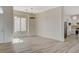 Open-concept space featuring stylish flooring, ample sunlight, and a partial view into the adjacent kitchen with stainless steel appliances at 10100 Folsom Dr, Las Vegas, NV 89134