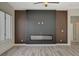 Living room featuring a modern fireplace, sleek design, and light wood-look floors at 10100 Folsom Dr, Las Vegas, NV 89134