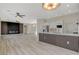 Open-concept living space featuring a modern kitchen with island and sleek flooring leading to an elegant living room at 10100 Folsom Dr, Las Vegas, NV 89134