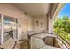 Inviting balcony space with seating, table, and views of lush greenery at 10109 Jacob Pl # 203, Las Vegas, NV 89144
