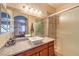 Elegant bathroom featuring a glass-enclosed shower, granite countertops, vessel sink and decorative mirrors at 10109 Jacob Pl # 203, Las Vegas, NV 89144