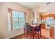 The dining area includes a window, a table with four chairs, and is adjacent to the kitchen at 10109 Jacob Pl # 203, Las Vegas, NV 89144