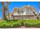 Beautiful entrance to the community featuring lush landscaping, a decorative wall, and community signage at 10109 Jacob Pl # 203, Las Vegas, NV 89144